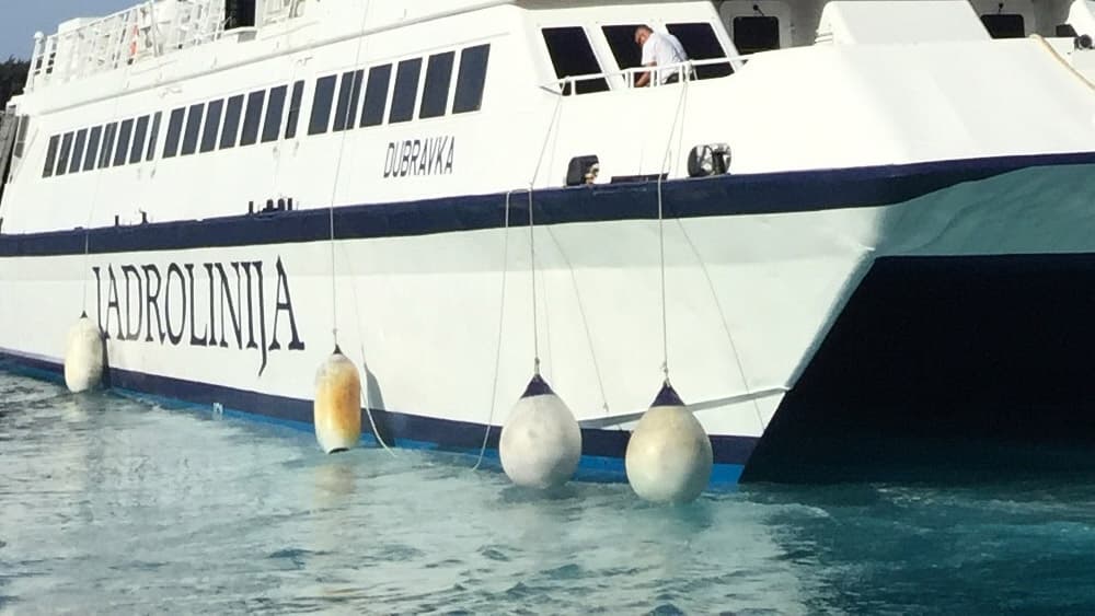 Boat fenders hang on a ferry boat.