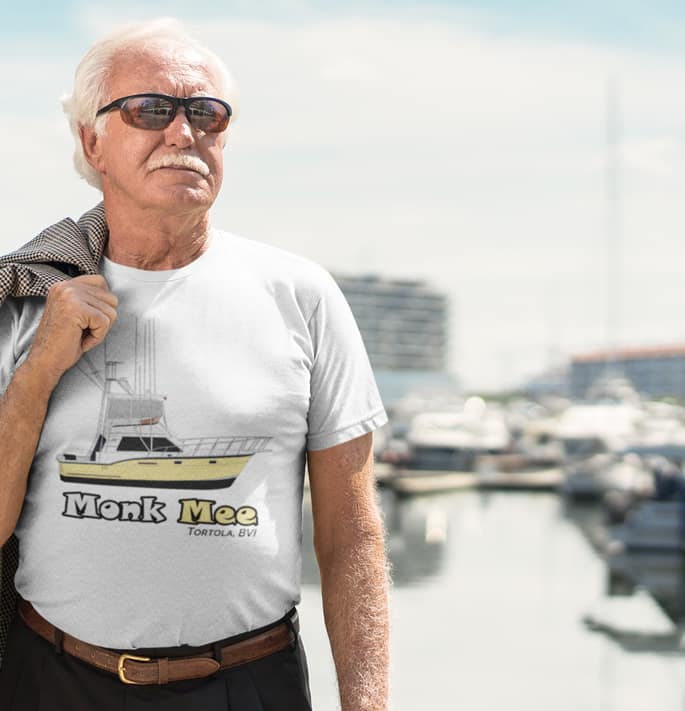 An image of a man wearing a custom boat shirt at a marina.