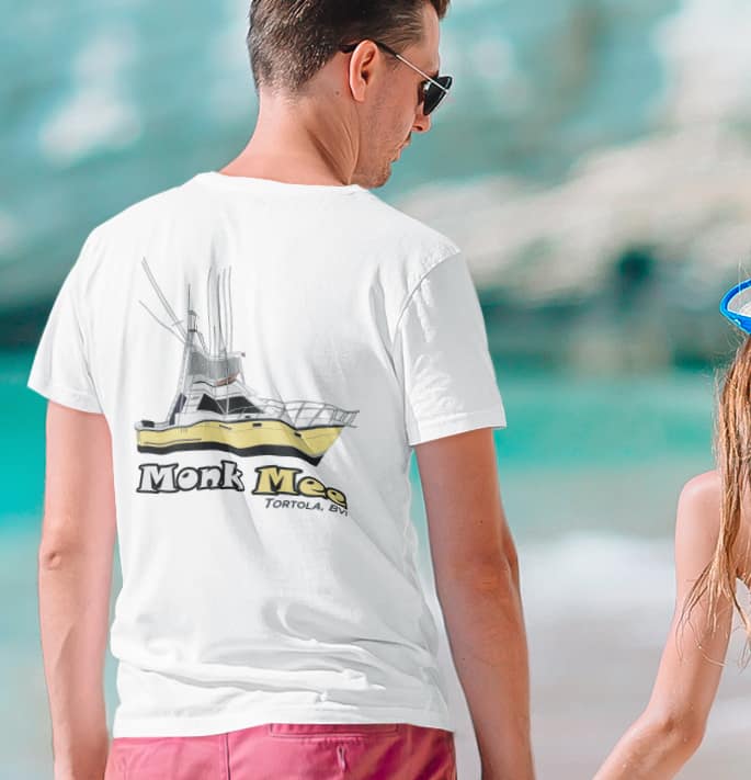 An image of a man wearing a custom boat shirt on the beach.