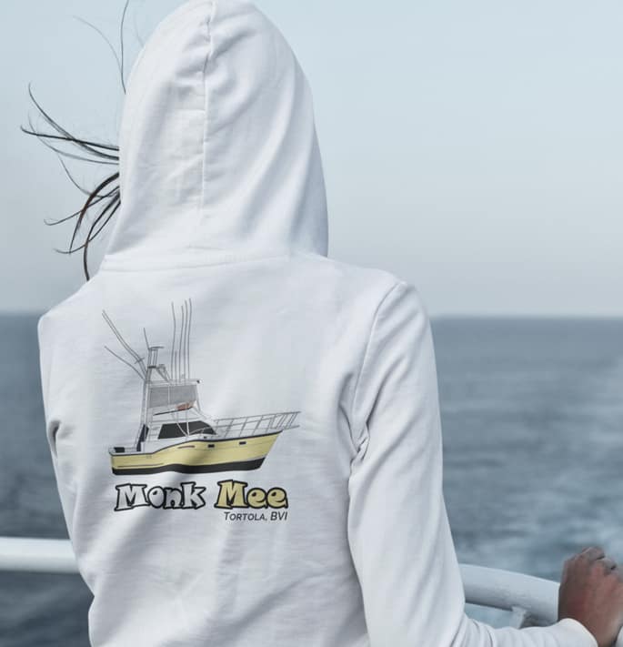 An image of a woman wearing a custom boat hoodie on a boat.