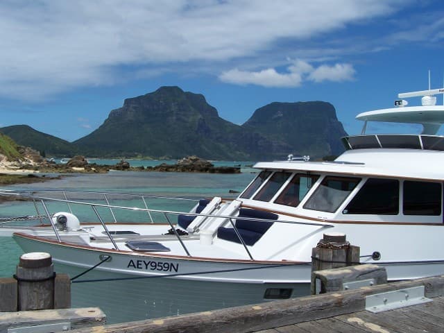 An image of a Marlow Explorer Yacht in a picturesque harbor.
