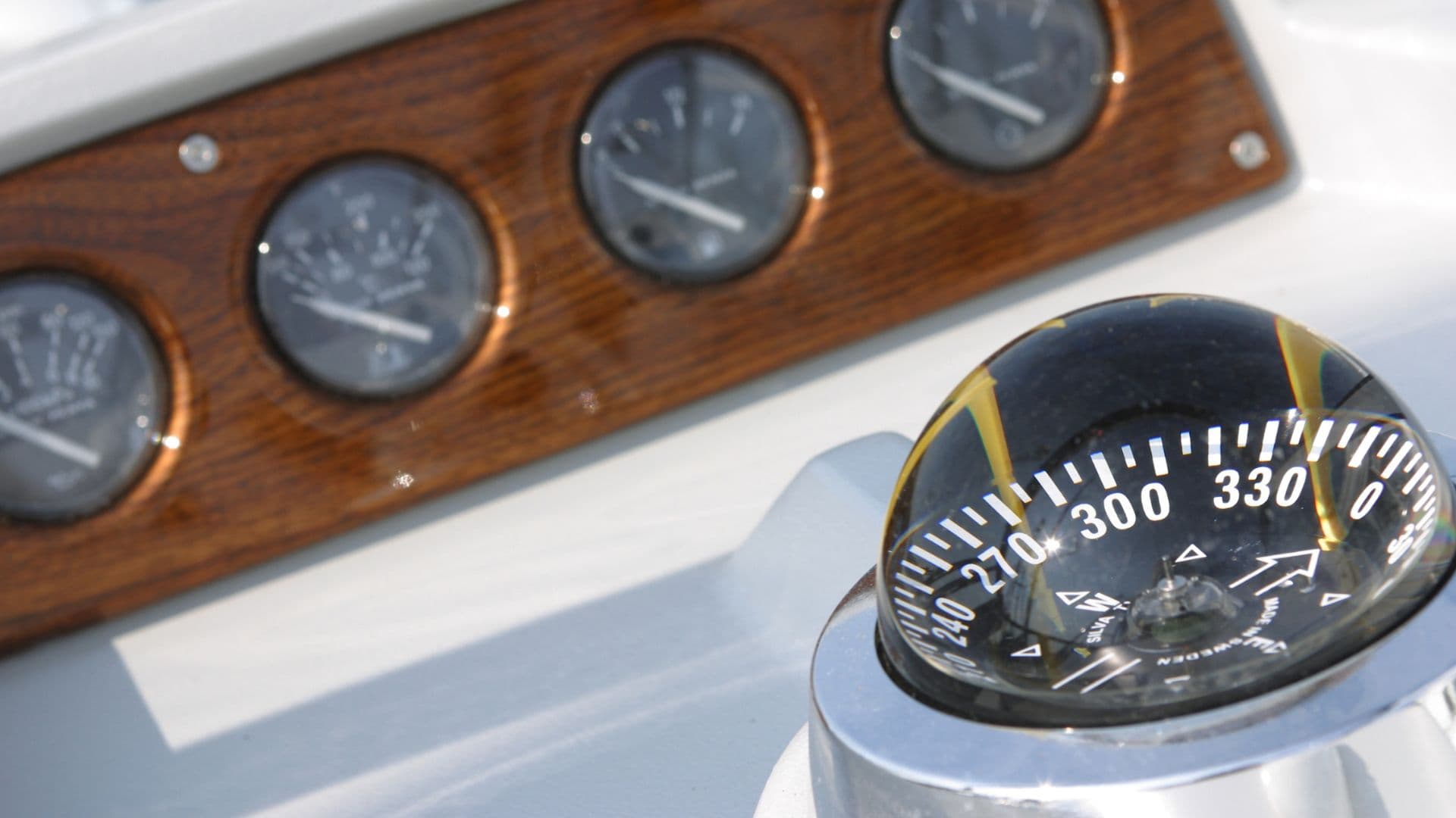 An image of a boat compass mounted on a boat. 
