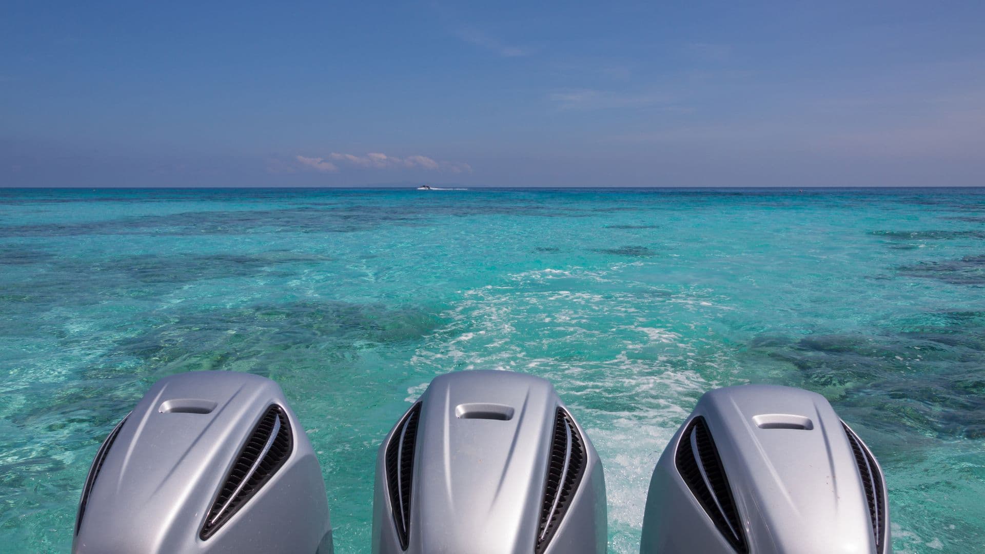 An image of outboard engines on a boat on a gorgeous clear day.
